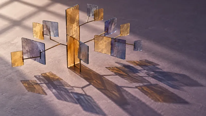 Translucent amber and blue panels branch from a central support, casting related shadows across a matte surface.